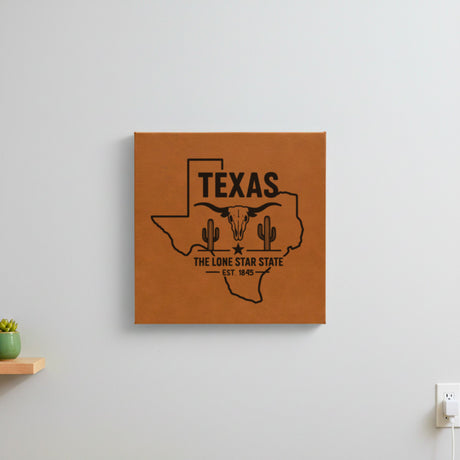 Brown leatherette wall sign engraved with a Texas design of a longhorn skull, cactus and a lone star, hanging on a wall