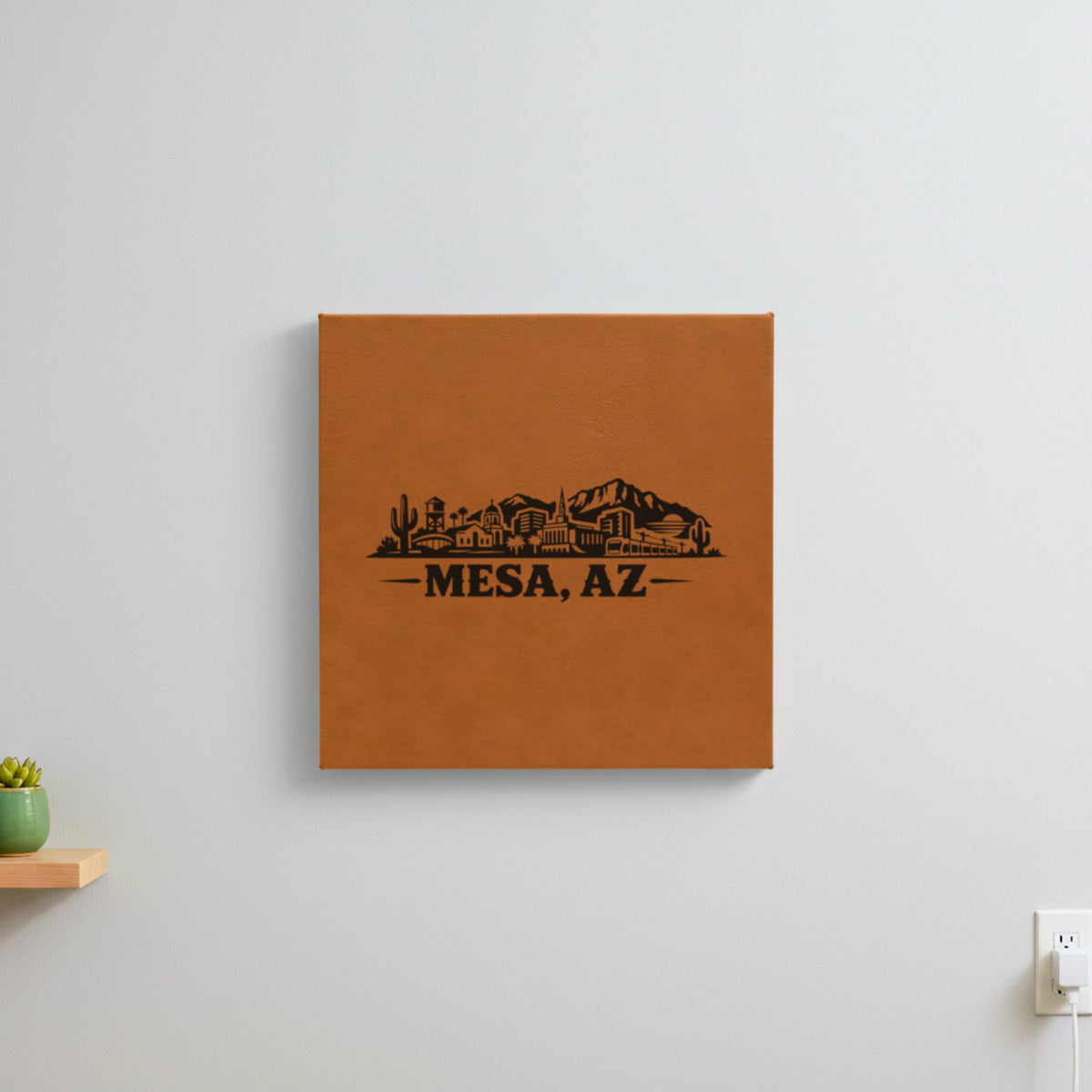 Brown leatherette wall sign engraved with the Mesa, Arizona skyline, hanging on a wall