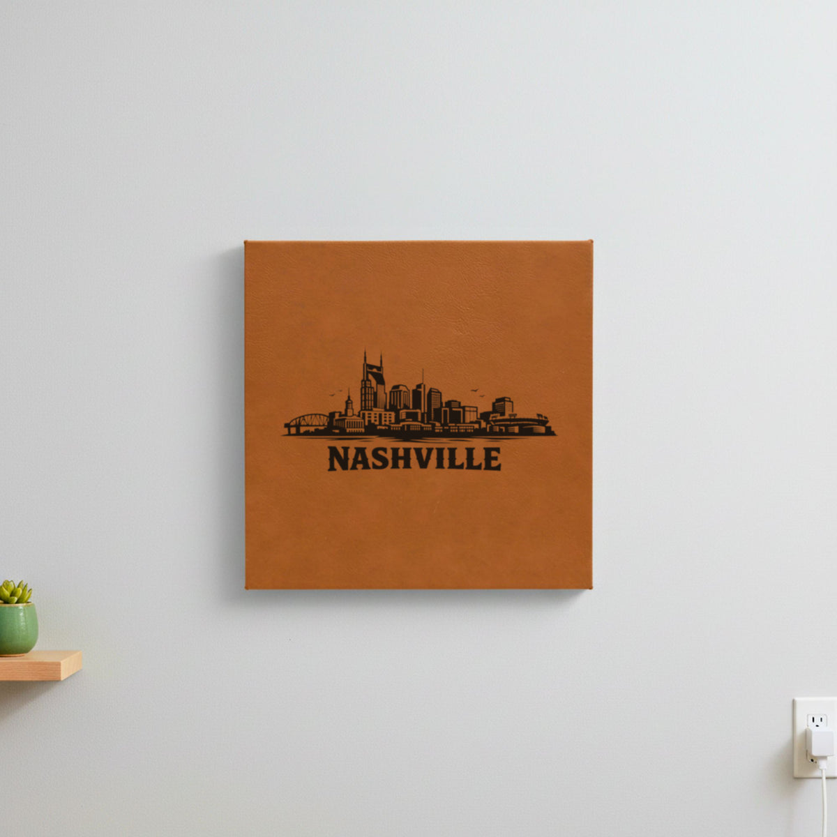 Brown leatherette wall sign engraved with the Nashville, Tennessee skyline, hanging on a wall