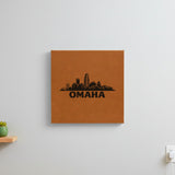 Brown leatherette wall sign engraved with the Omaha, Nebraska skyline, hanging on a wall