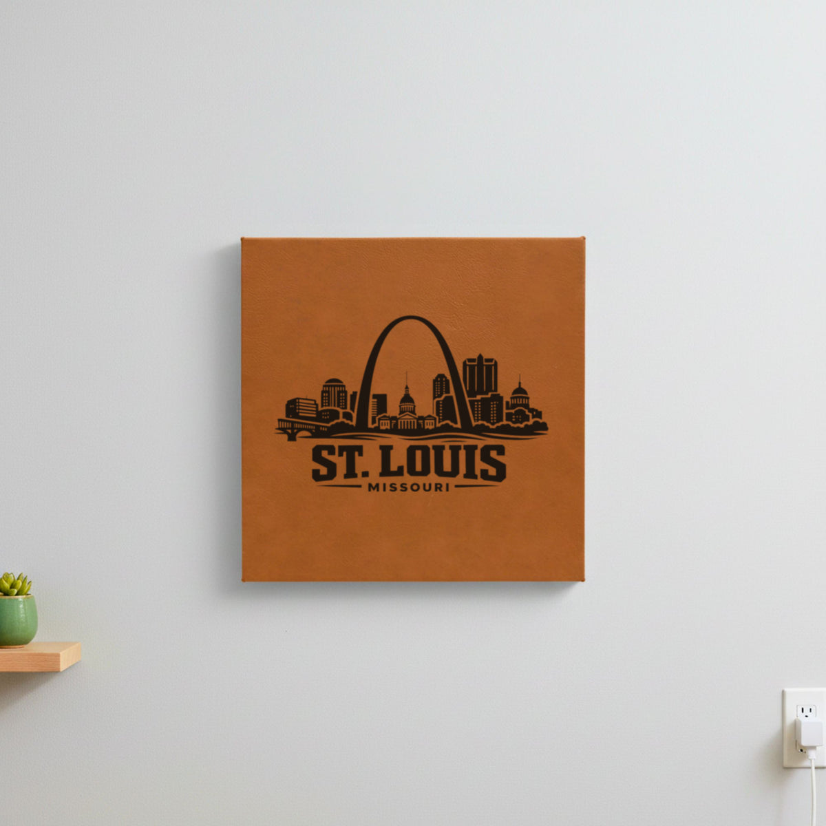 Brown leatherette wall sign engraved with the St. Louis, Missouri skyline, hanging on a wall