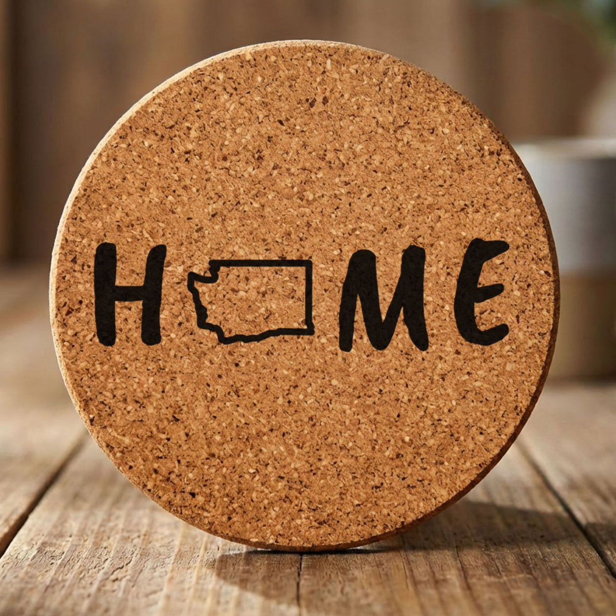Washington round cork coaster engraved with HOME using the state outline as the letter O