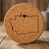 Washington round cork coaster engraved with the state outline and home in script with a heart