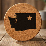 Washington round cork coaster engraved with the state shape and a star