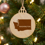 Washington round wood Christmas ornament engraved with the state shape and WASHINGTON in bold lettering