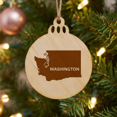 Washington round wood Christmas ornament engraved with the state shape and WASHINGTON in bold lettering