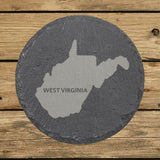 West Virginia round slate coaster engraved with the state shape and WEST VIRGINIA in bold lettering
