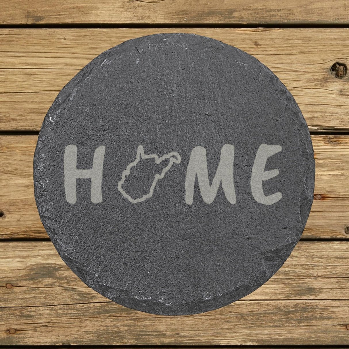 West Virginia round slate coaster engraved with HOME using the state outline as the letter O