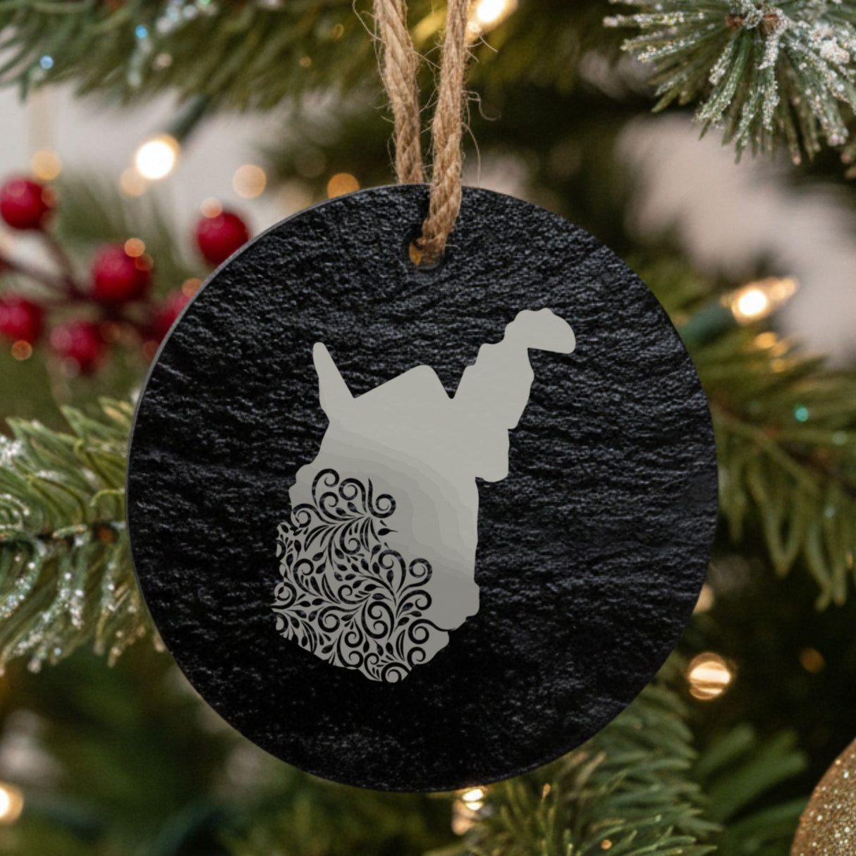 West Virginia round slate Christmas ornament engraved with the state shape in ornate floral scrollwork