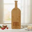 Bamboo wine bottle shaped cutting board laser engraved with "Furry and Bright"