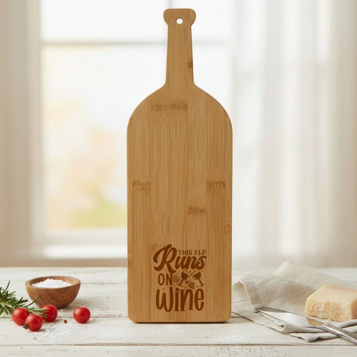 Bamboo wine bottle shaped cutting board laser engraved with "This Elf Runs on Wine"