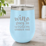 Light Blue 12 oz stemless wine tumbler laser engraved with "Wine Goes In, Wisdom Comes Out", on a kitchen counter