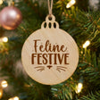 Round wood Christmas ornament laser engraved with "Feline Festive"