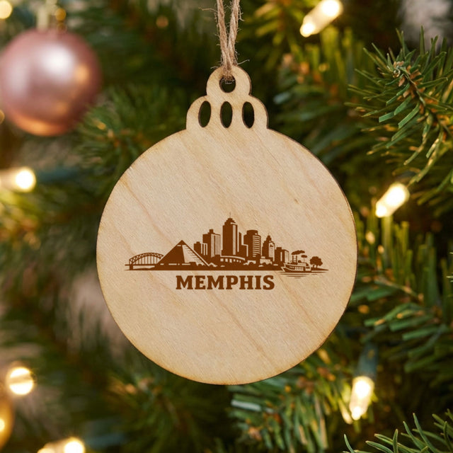 Memphis, Tennessee skyline engraved on a round wood Christmas ornament