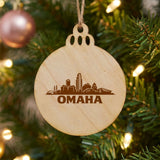 Omaha, Nebraska skyline engraved on a round wood Christmas ornament