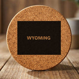 Wyoming round cork coaster engraved with the state shape and WYOMING in bold lettering
