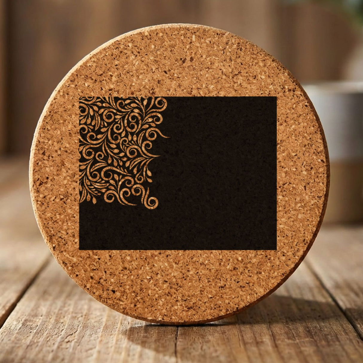 Wyoming round cork coaster engraved with the state shape in ornate floral scrollwork
