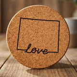 Wyoming round cork coaster engraved with a hand-drawn state outline and love in cursive