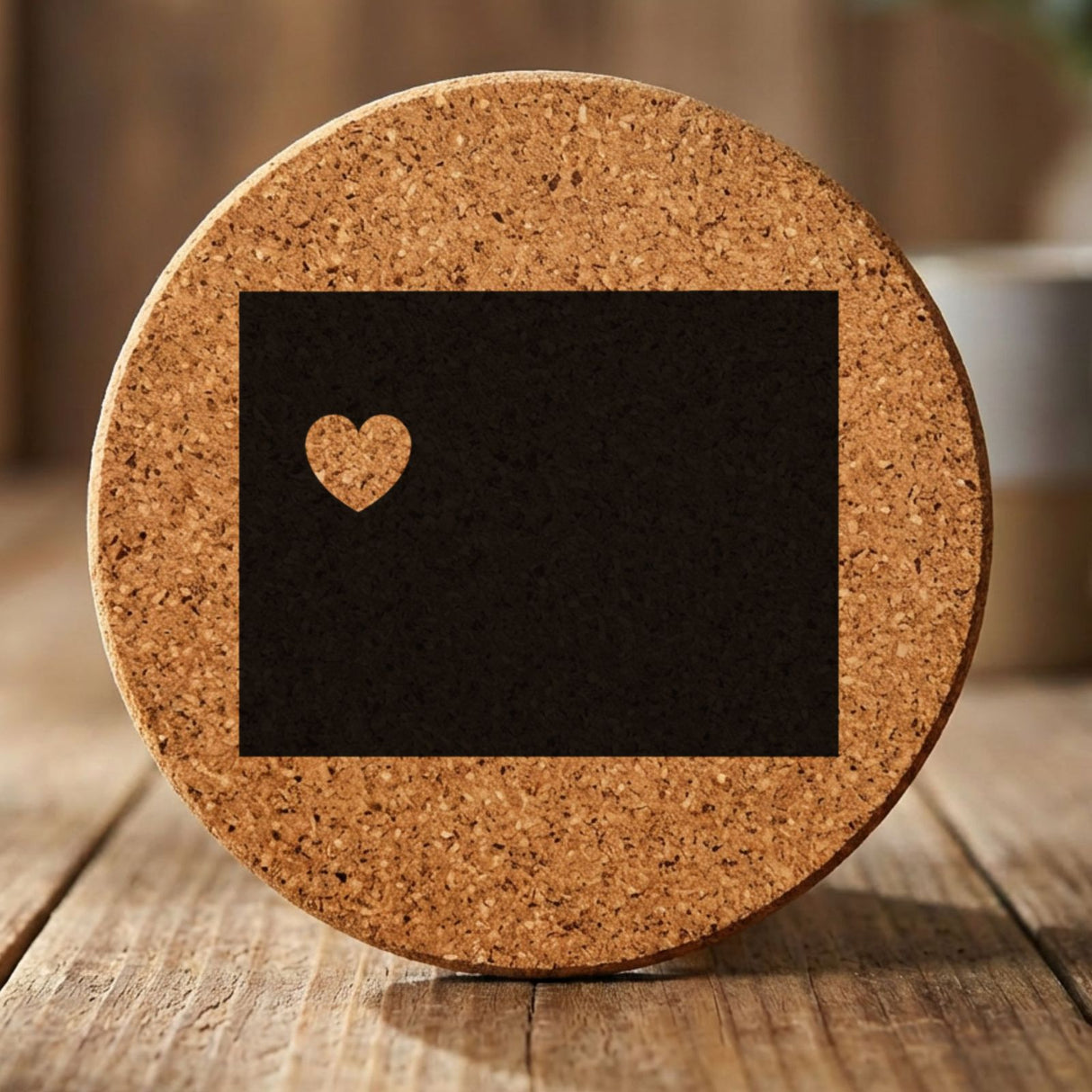 Wyoming round cork coaster engraved with the state shape and a heart