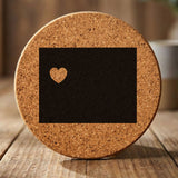 Wyoming round cork coaster engraved with the state shape and a heart