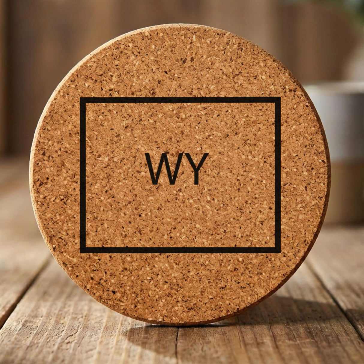 Wyoming round cork coaster engraved with the state outline and WY initials