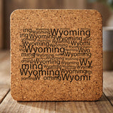 Wyoming square cork coaster engraved with a word cloud of repeating Wyoming text