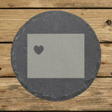 Wyoming round slate coaster engraved with the state shape and a heart