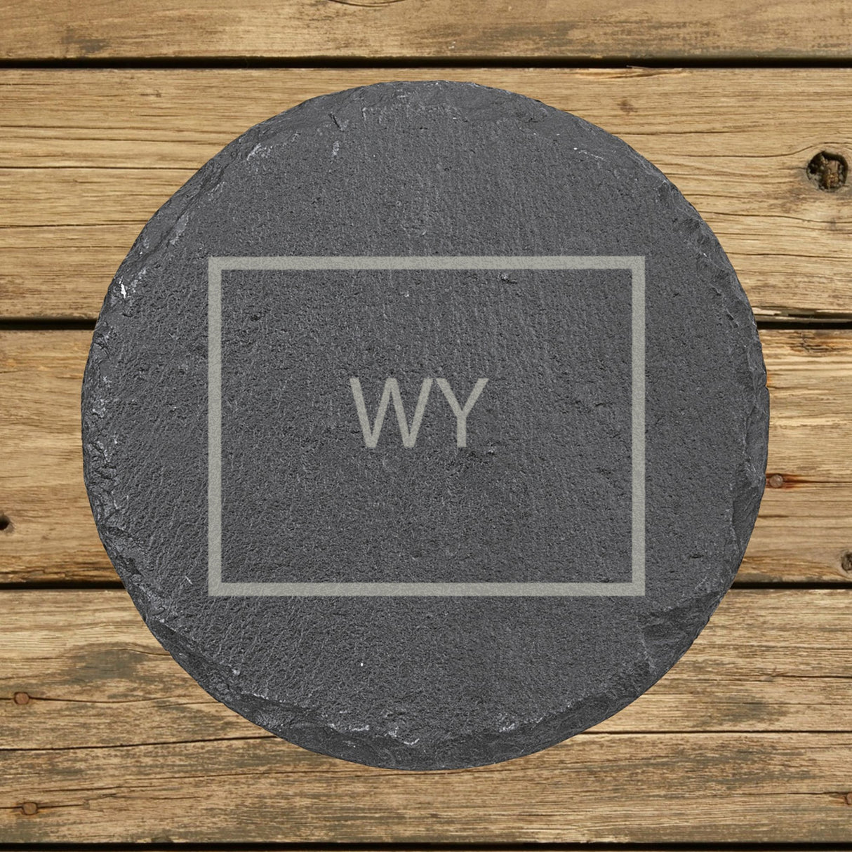 Wyoming round slate coaster engraved with the state outline and WY initials