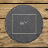 Wyoming round slate coaster engraved with the state outline and WY initials