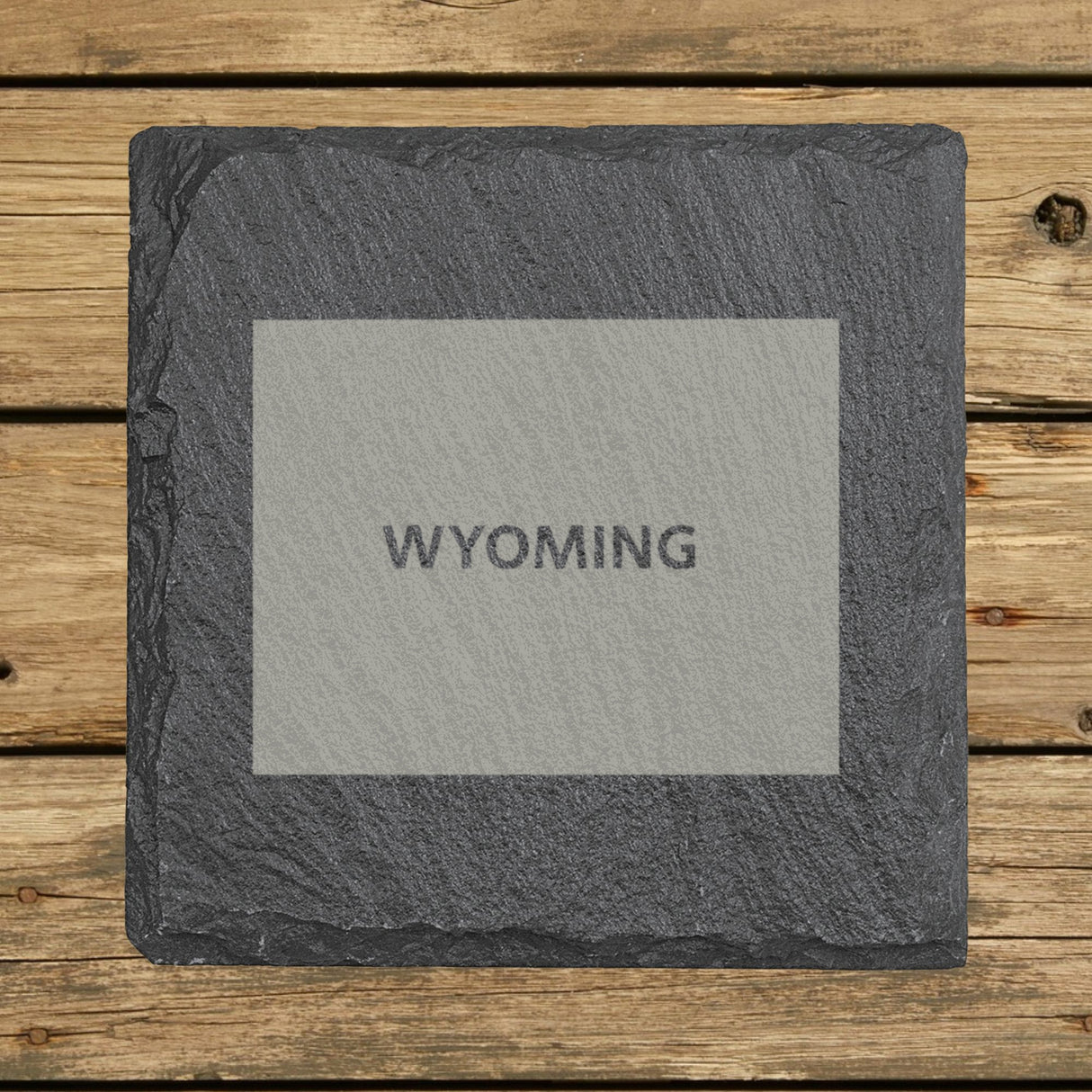 Wyoming square slate coaster engraved with the state shape and WYOMING in bold lettering