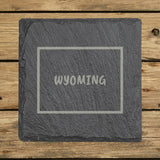 Wyoming square slate coaster engraved with the state outline and WYOMING in hand-drawn brush lettering