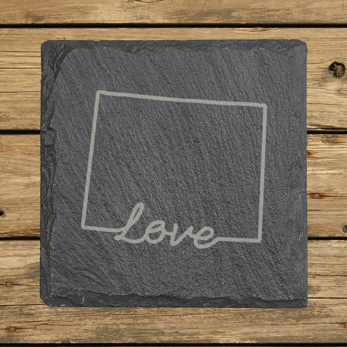Wyoming square slate coaster engraved with a hand-drawn state outline and love in cursive