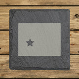 Wyoming square slate coaster engraved with the state shape and a star